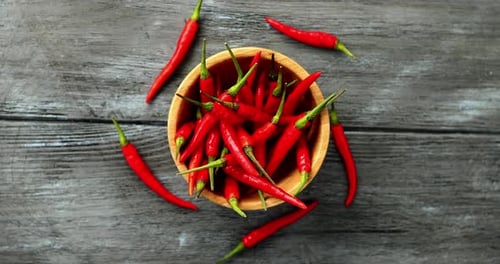 Red Chili Peppers in Wooden Bowl on Table