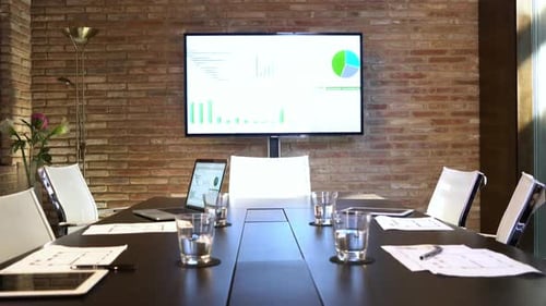 Modern Conference Room with Technology and Graph Displays