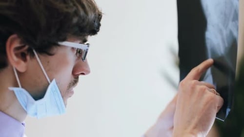 Medical Professional Analyzing X-Ray in Hospital Setting