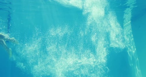 Man Diving into Blue Swimming Pool