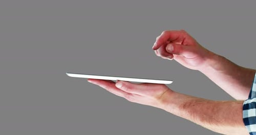 Hand Interacting with Tablet on Grey Background