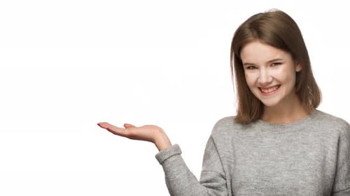 Portrait of Pleased Woman 20s Wearing Basic Clothing Laughing and and Presenting Copyspace Text or