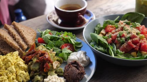 Healthy Vegan Brunch in the City. Close Up of Full English Breakfast, Salad with Spinach, Coffee and