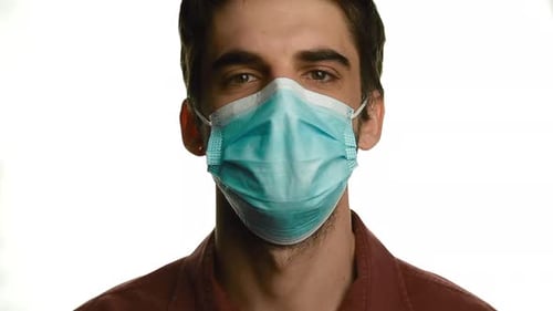 Man Wearing and Removing Blue Medical Face Mask