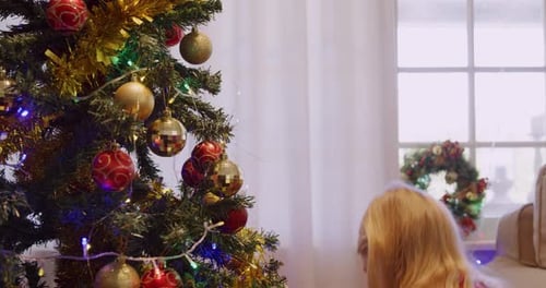 Girl Decorating Christmas Tree with Ornaments