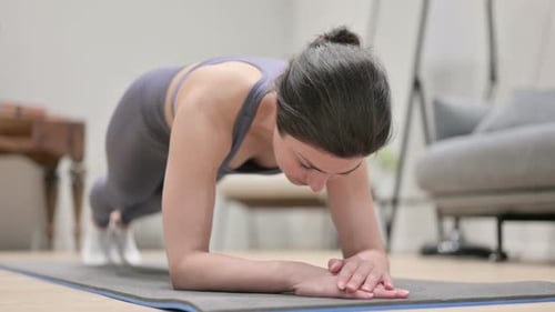 Woman Does Forearm Plank on Exercise Mat at Home
