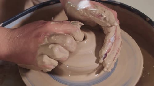 Hands Shaping Clay on Pottery Wheel, Close Up