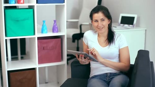Woman Using Tablet Device Indoors at Home