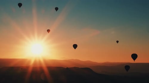 Hot Air Balloons Silhouetted at Desert Sunrise