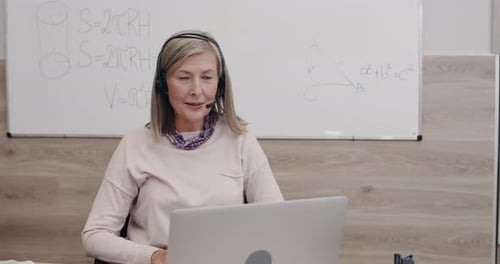 Teacher Leading Online Class from Workplace