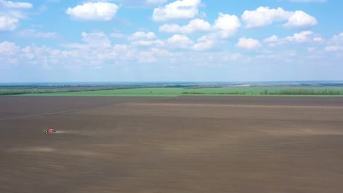 Working At The Field Tractor With The Seeder 16