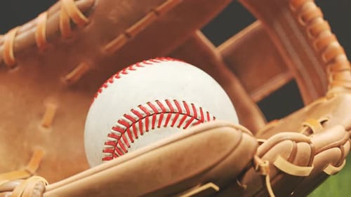 Vintage leather baseball glove with a ball lying down in a stadium spotlight 4K