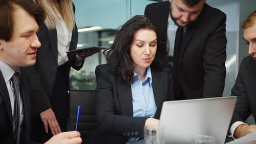 Business Team Collaborates on Computer in Modern Office