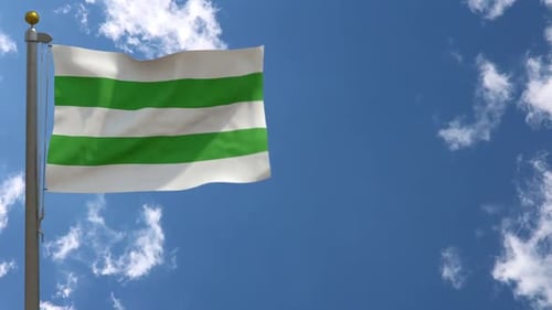 Waving Flag with Green and White Stripes Against Blue Sky