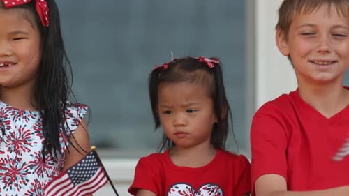 Children Waving American Flags in Patriotic Celebration