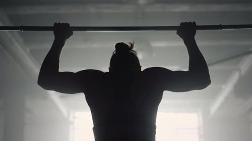 Man Doing Wide Grip Pull Ups on Bar