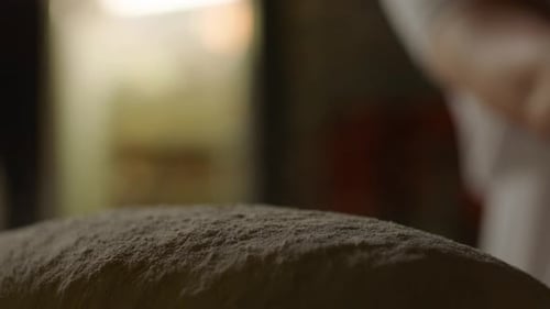 Tirar harina a mano sobre la masa de pan