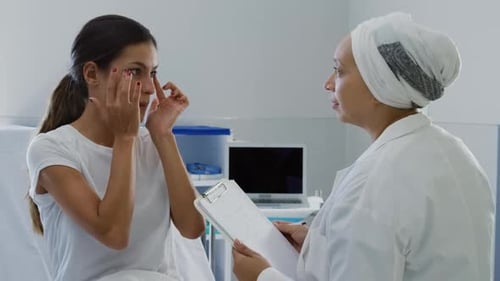 Doctor Consults with Patient in Hospital Room