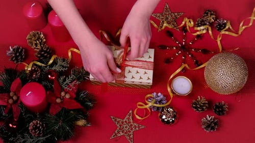 Close Up Woman Hand and Decorate Christmas Gift Box.