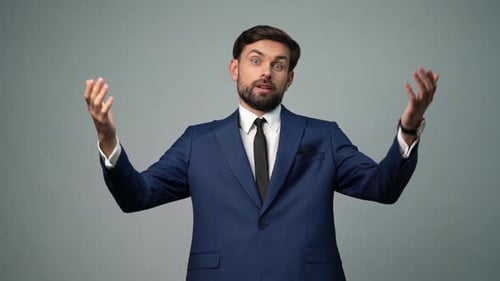 Man in Suit with Arms Up in Studio