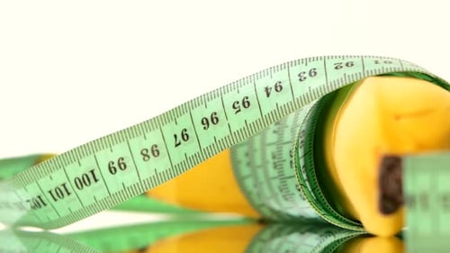 Banana Wrapped Up with Measure Tape, Reflection, Rotation, Close Up, on Black