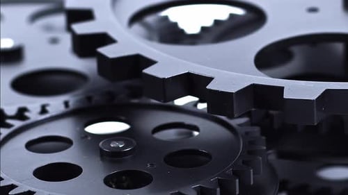 Black Gears Turning in a Close Up