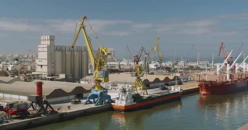 Loading a Cargo Ship at the Seaport. Port with Large Ships and Cranes, Timelapse.