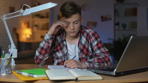 Left-Handed Overloaded Teenage Student Preparing for Examination