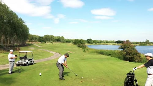 4K Aerial view group of Asian people golfing on at golf course in summer sunny day.