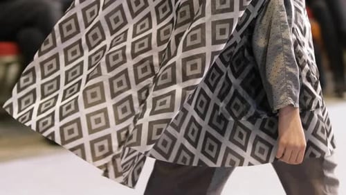 Woman Model in Grey Square Pattern Dress Walks Down Runway