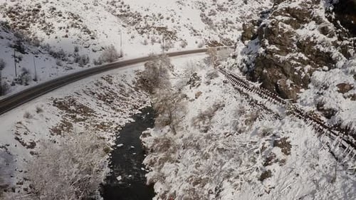 Snowy Mountains and Winding River Aerial View