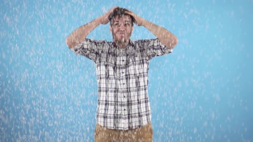 Man Reacts to Unexpected Snowfall in Studio
