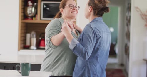 Two Women Dancing Together in Their Home