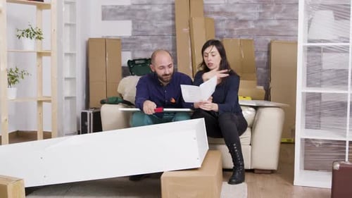 Couple caucasien se disputant tout en assemblant une étagère