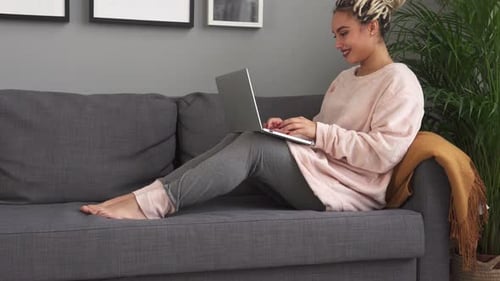 Woman with Blonde Braids Working on Laptop at Home