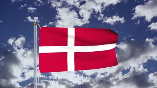 Danish Flag Waving on a Pole Against Blue Sky with Clouds