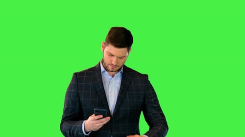 Man in Blazer Uses Cellphone on Green Screen