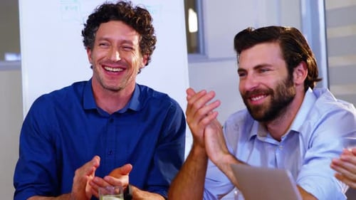 Cheerful Business Team Clapping in a Modern Office