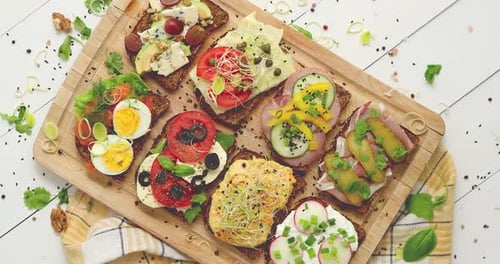 Delicious Open Faced Sandwiches on Wooden Cutting Board