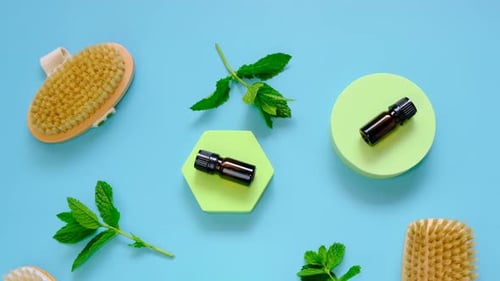 Essential Oils and Brushes on Blue Surface