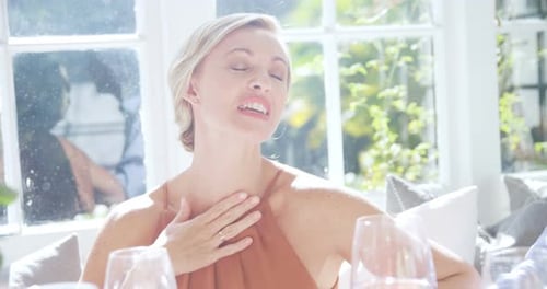 Group of friends interacting while having wine