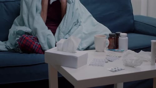 Sick Man with Cold Using Tissues