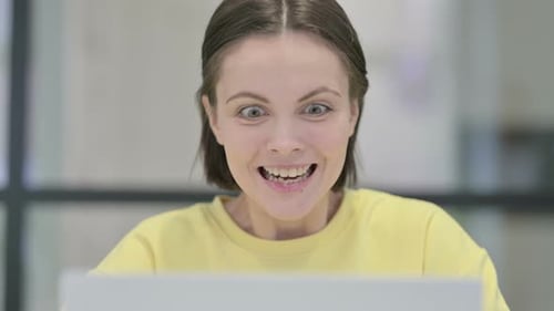 Close Up of Woman Celebrating Success on Laptop