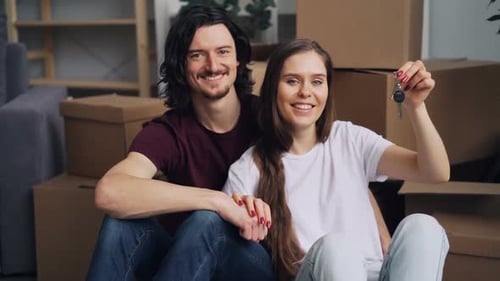 Cheerful Couple Holding New House Keys After Move
