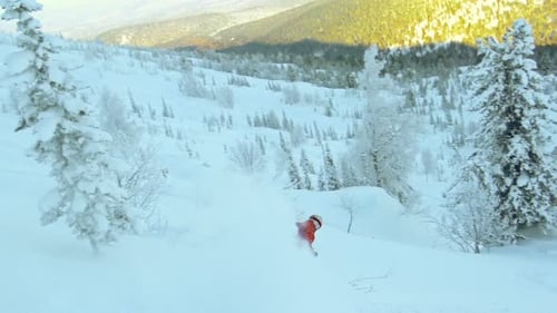 Skier Glides Down Snow Covered Mountain