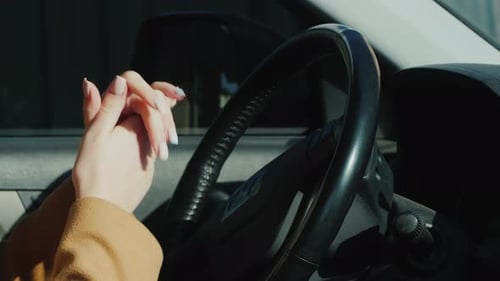 Woman Uses Hand Sanitizer in Car