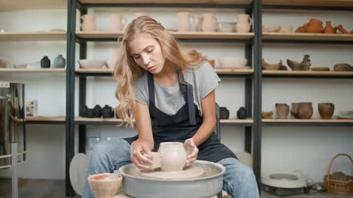 Woman Shaping Clay Pot on Pottery Wheel