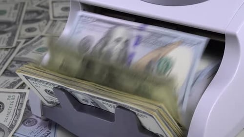 Currency Counter Counts US Hundred Dollar Bills