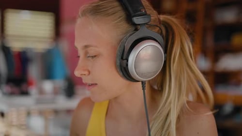 Young Woman Wearing Headphones Looking at Camera