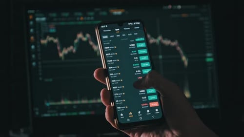 Hand Using Finance App with Graph Background